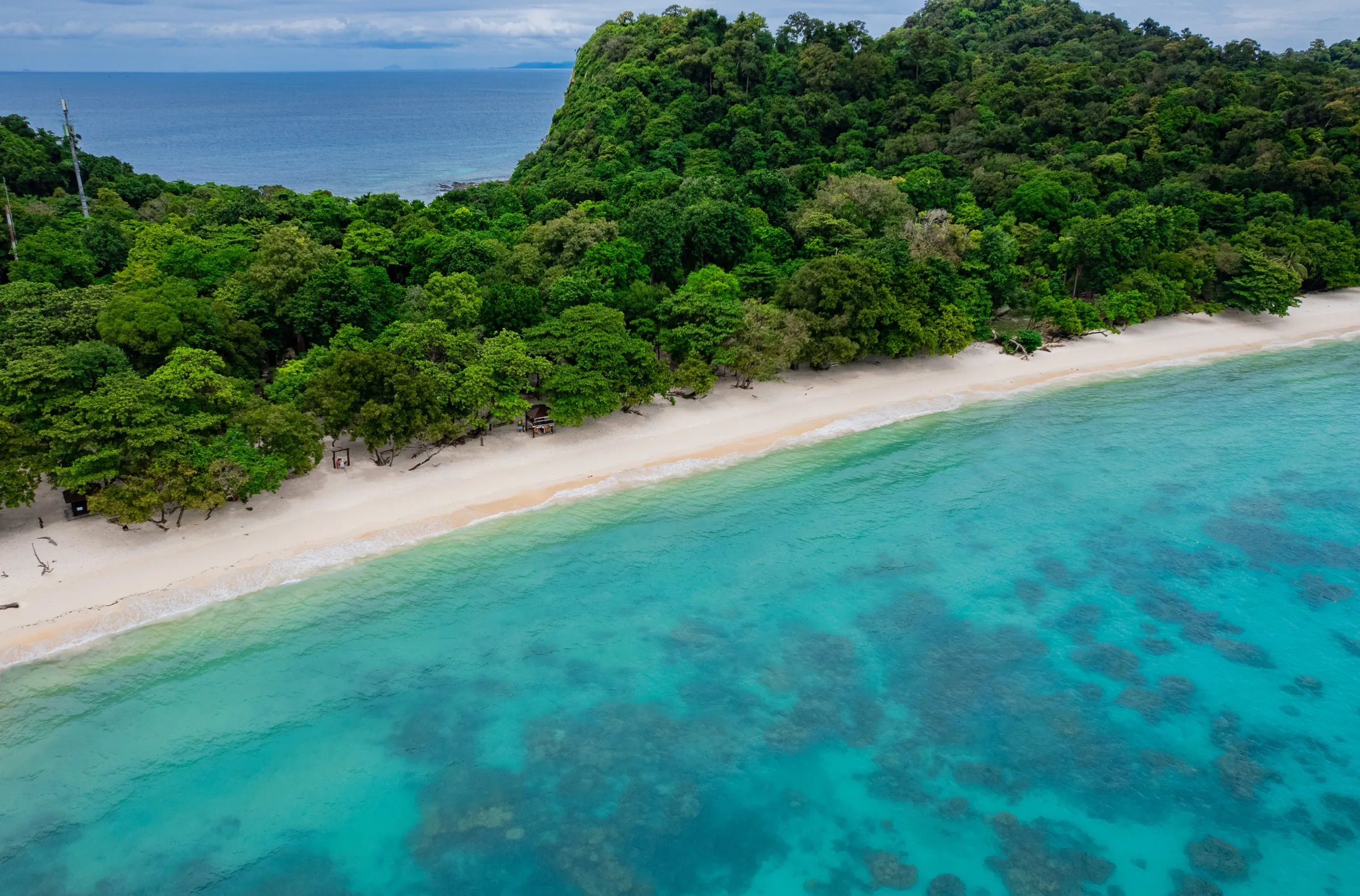 White-sand coastline and turquoise water at Rok Island