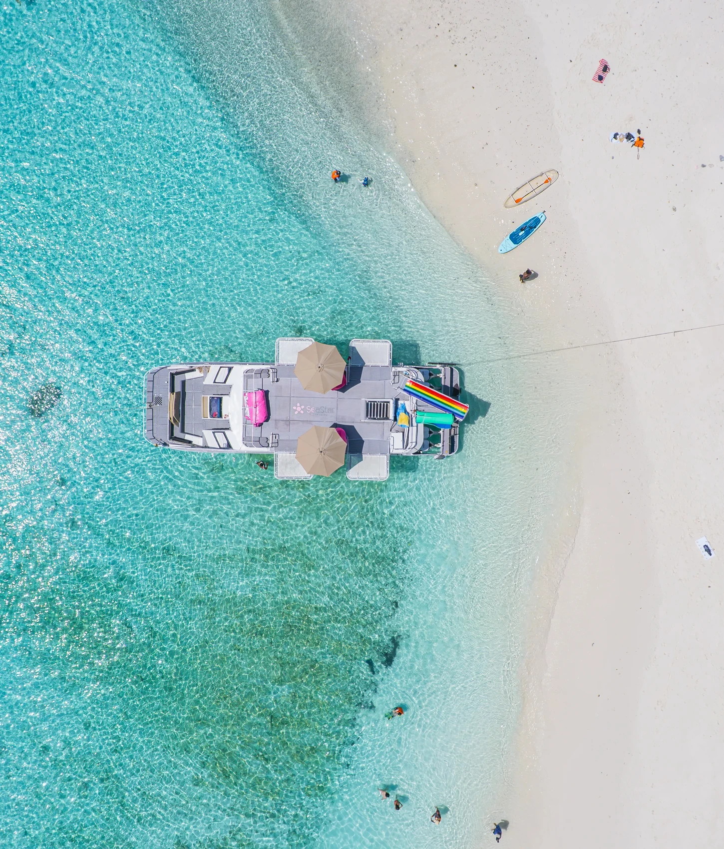White-sand beach and transparent turquoise water seen from above
