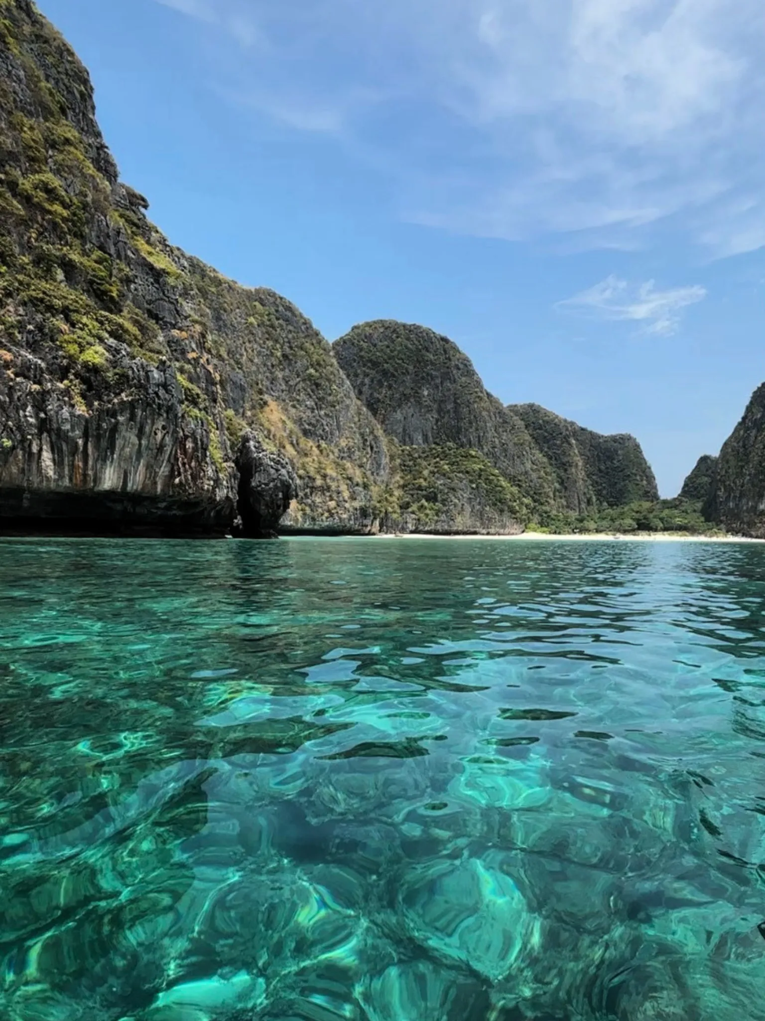 Emerald cove surrounded by tropical limestone cliffs