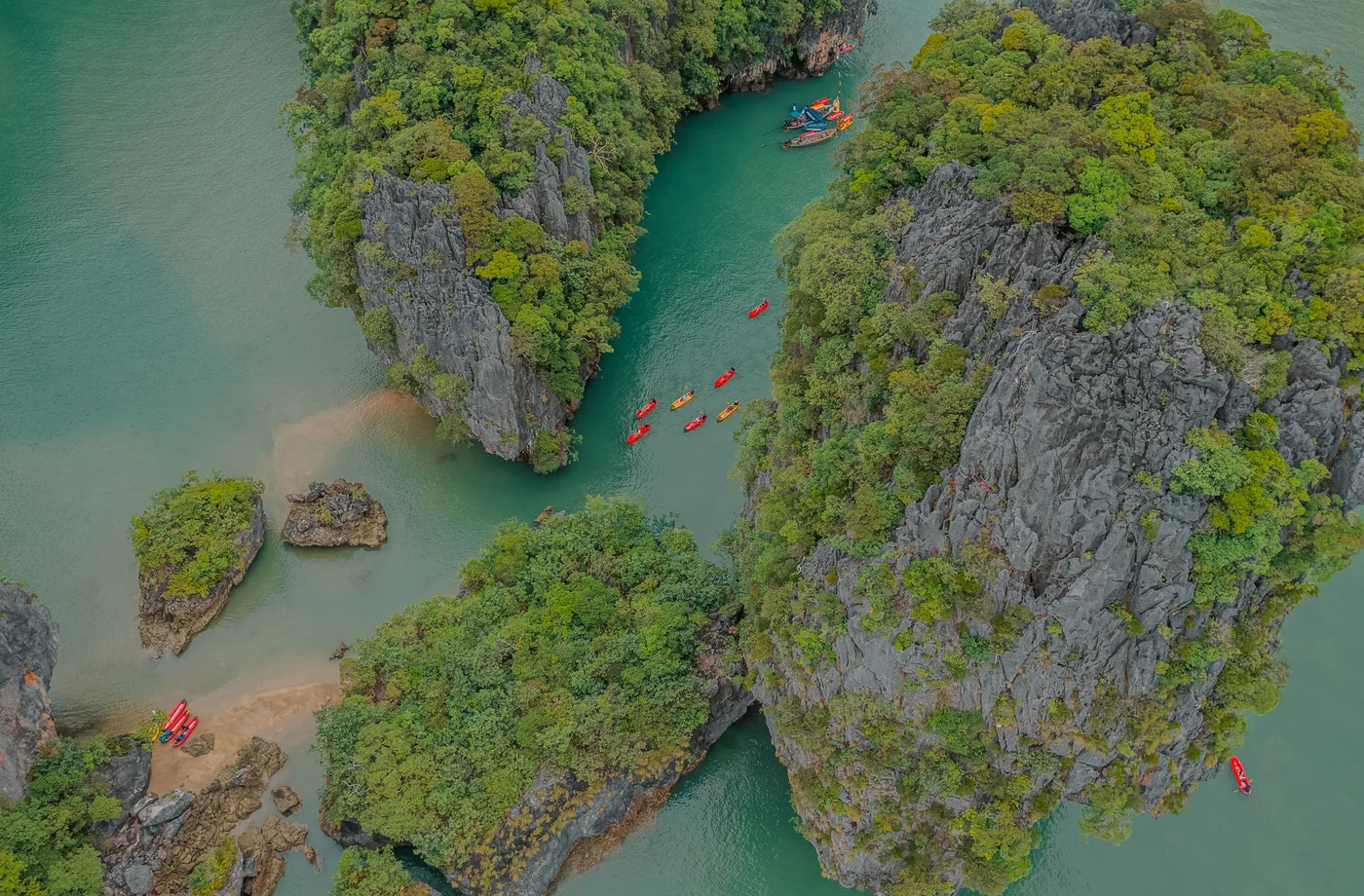 Canoes entering a hidden channel among limestone islands