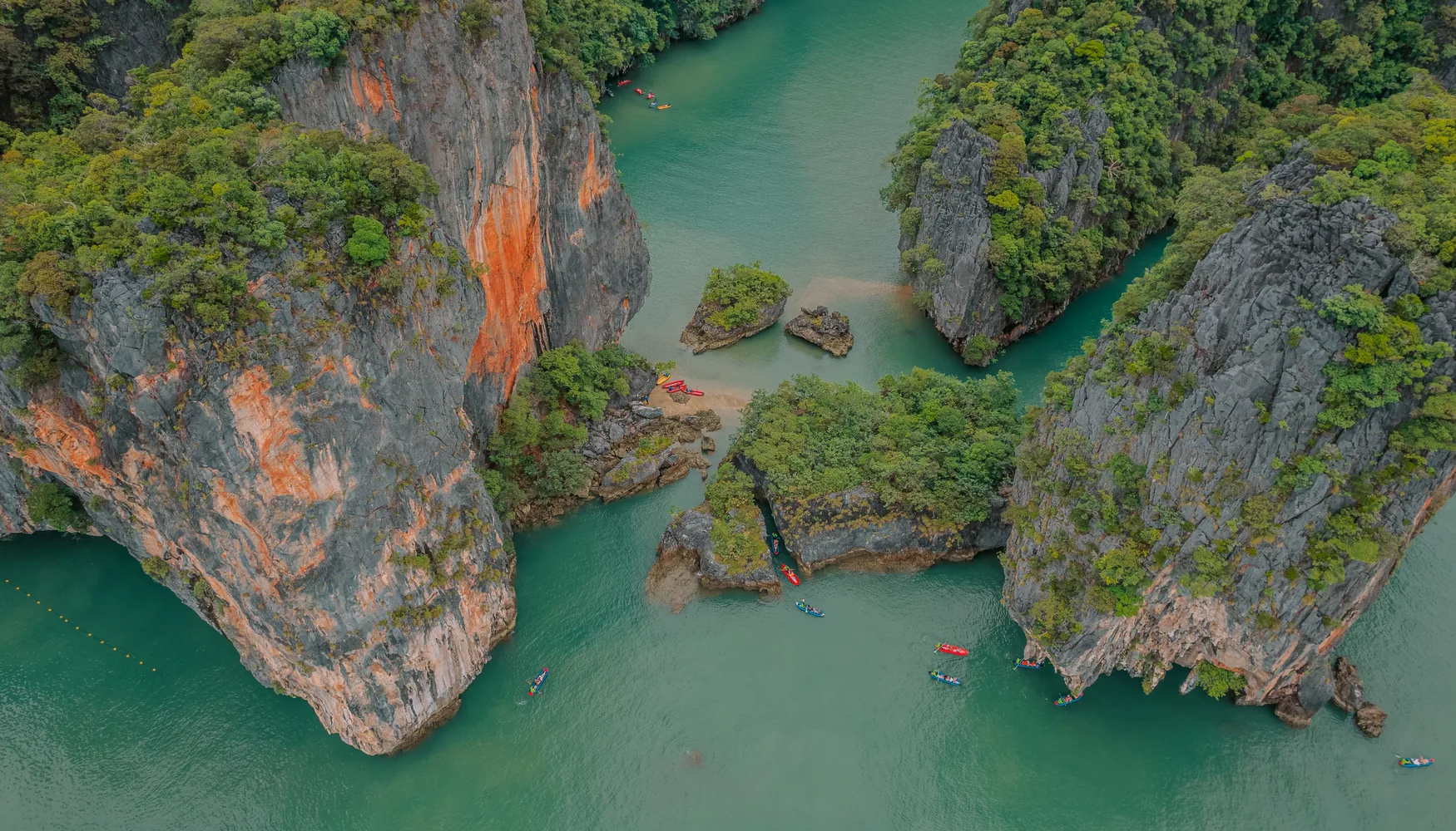 Aerial view of limestone cliffs and canoes in Phang Nga Bay